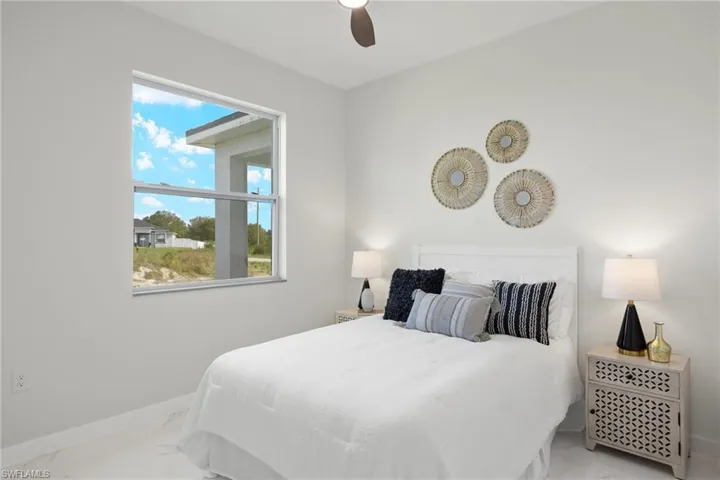 Bedroom with multiple windows and ceiling fan