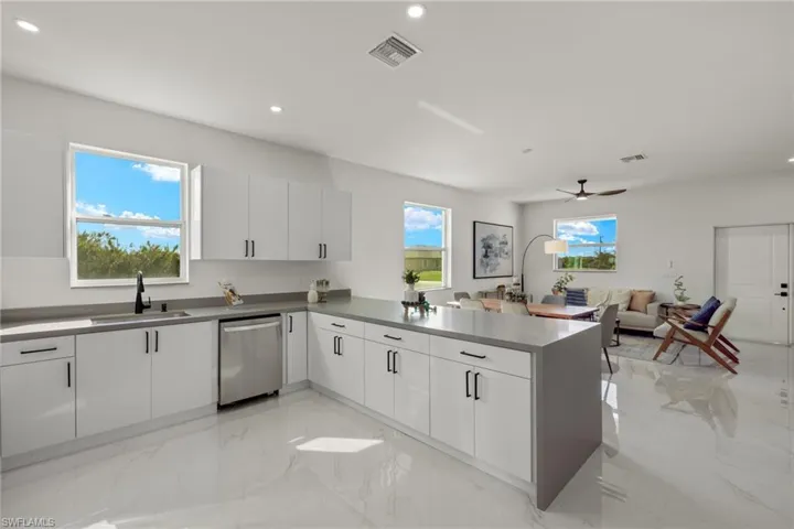 Kitchen with white cabinets and a wealth of natural light