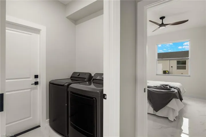 Washroom featuring independent washer and dryer and ceiling fan