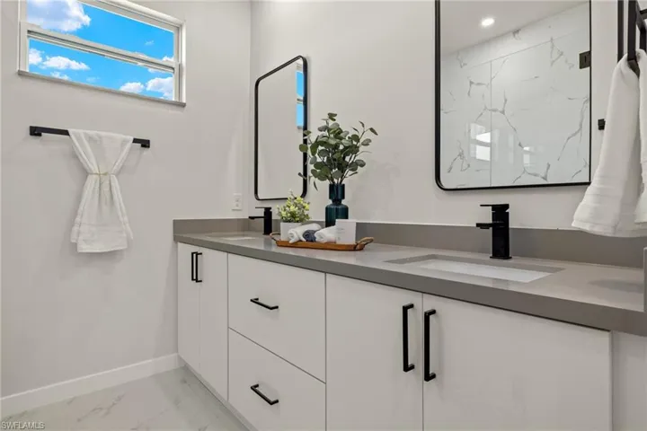 Bathroom with vanity and a shower