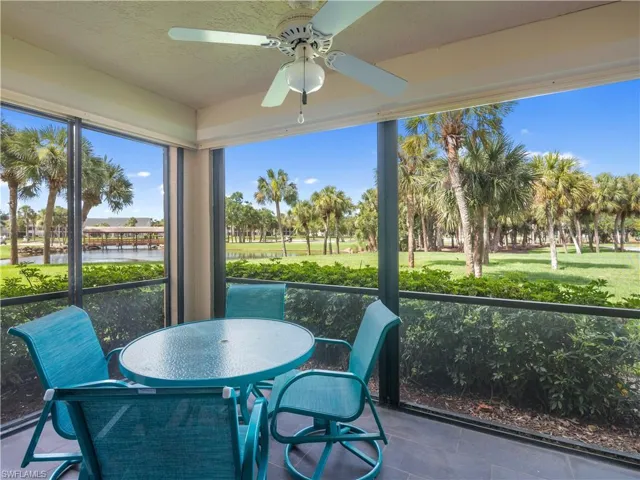 Sunroom / solarium with a textured ceiling, outdoor dining area, a water view, and a ceiling fan