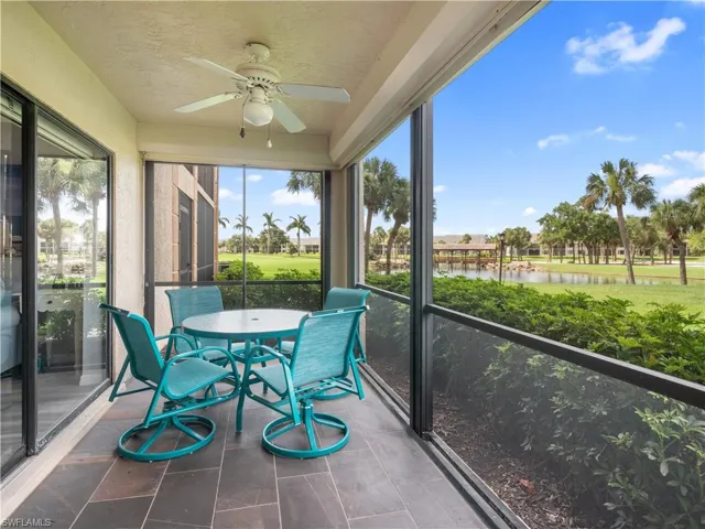 Sunroom featuring a water view and ceiling fan