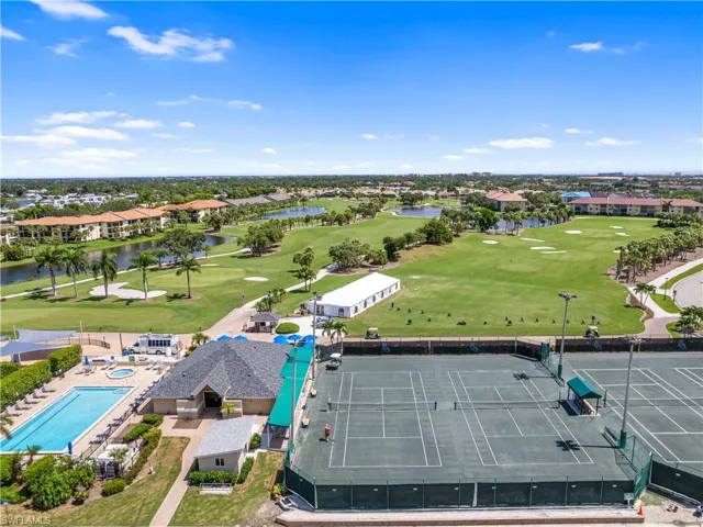 Aerial view featuring a water view and golf course view