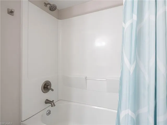 Bathroom with shower / bathtub combination with curtain