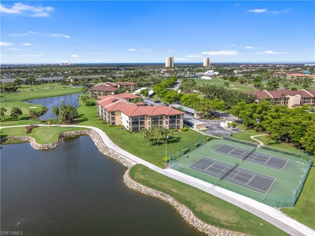 Drone / aerial view featuring golf course view and a water view