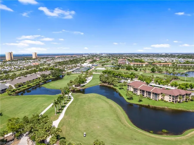 Birds eye view of property with a water view and golf course view