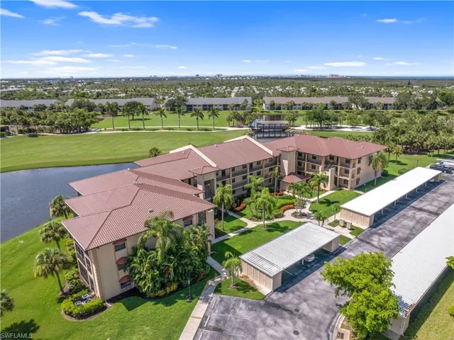 Birds eye view of property with a water view