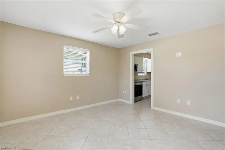 Unfurnished room featuring a ceiling fan and light tile patterned floors