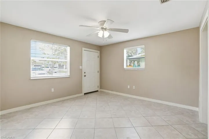 Entrance foyer with a ceiling fan and light tile patterned floors