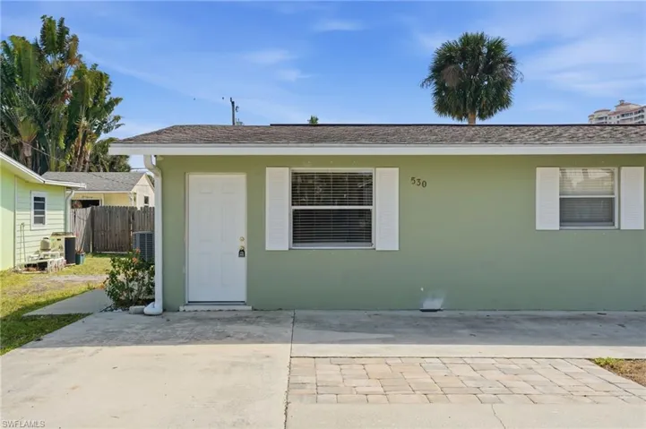 View of front facade with stucco siding and a patio