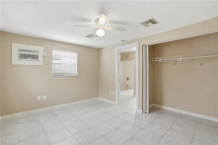 Unfurnished bedroom featuring a ceiling fan and baseboards