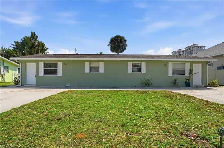 Single story home with a front yard and stucco siding