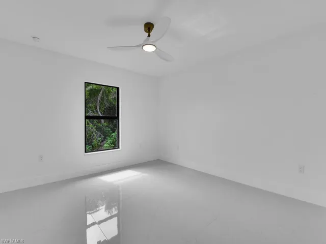 Spare room with tile patterned floors and ceiling fan