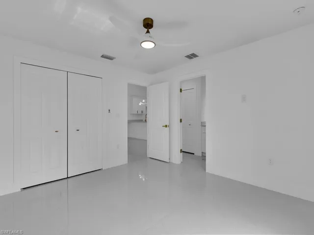 Unfurnished bedroom with tile patterned floors, a closet, and ceiling fan