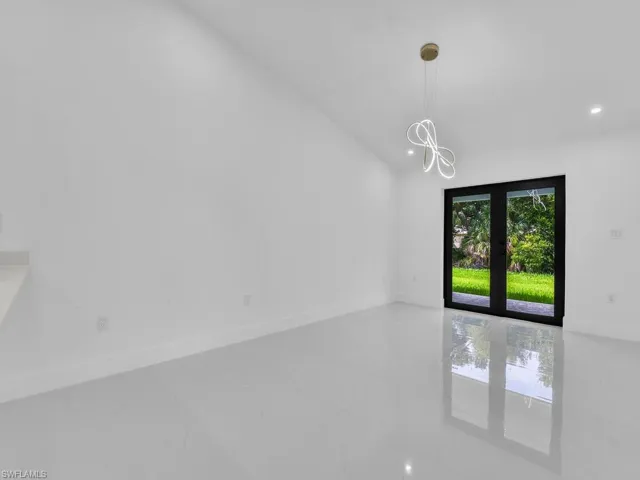 Unfurnished room featuring french doors and tile patterned floors