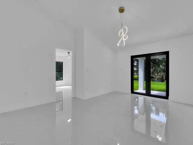 Empty room with tile patterned flooring and french doors