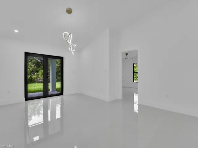 Tiled empty room with french doors