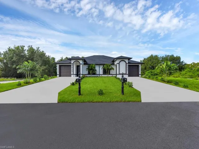 Single story home with a garage and a front yard