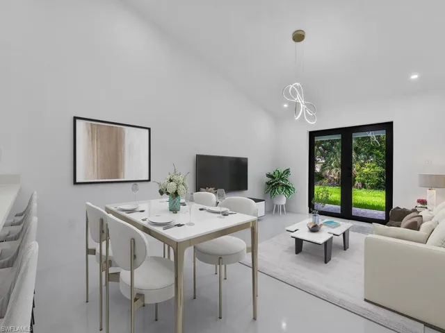 Living room with french doors and high vaulted ceiling