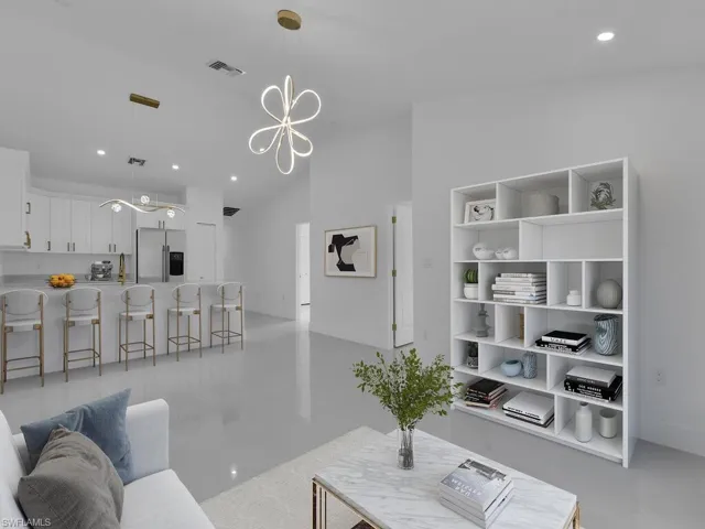 Tiled living room with a notable chandelier and vaulted ceiling