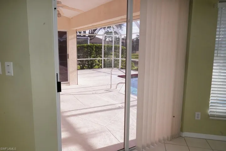 Doorway featuring tile patterned floors and baseboards