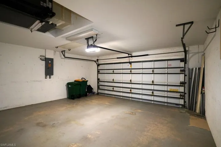 Garage with electric panel and a garage door opener
