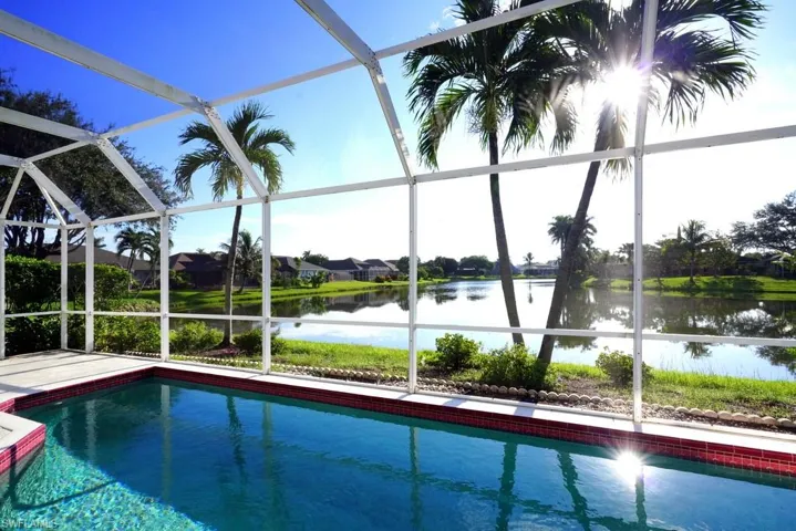 Swimming pool with a water view, a lanai, and a sunroom