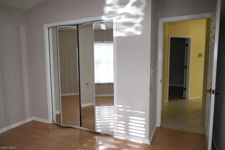 Unfurnished bedroom featuring light wood-style flooring and a closet