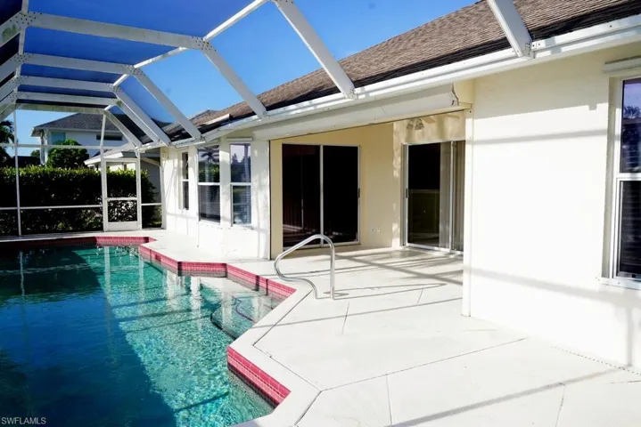 Outdoor pool with a sunroom, a lanai, and a patio area