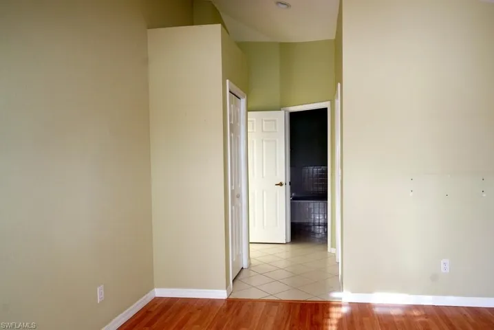 Empty room with light wood-type flooring and baseboards