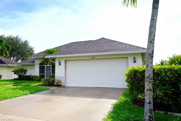 Ranch-style home featuring stucco siding, a shingled roof, concrete driveway, and a garage