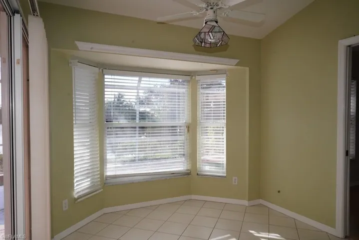 Unfurnished room featuring light tile patterned floors and ceiling fan