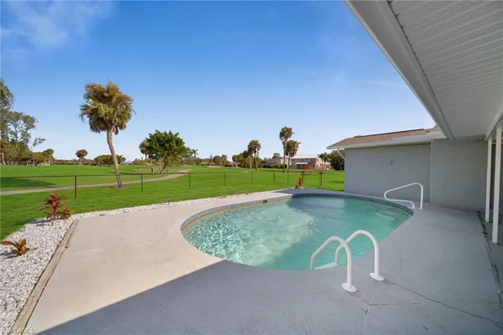 View of pool with a yard and a patio