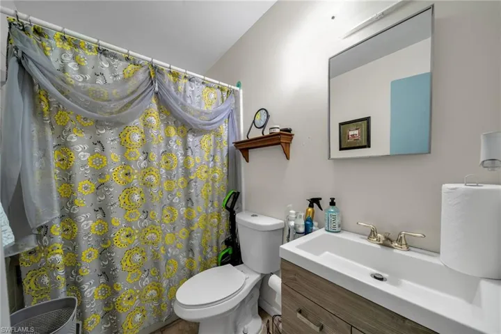 Bathroom with vanity and curtained shower
