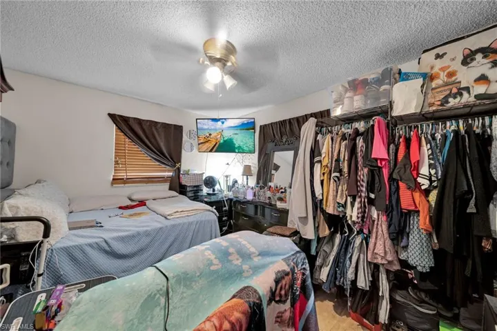 Bedroom featuring a textured ceiling and a ceiling fan