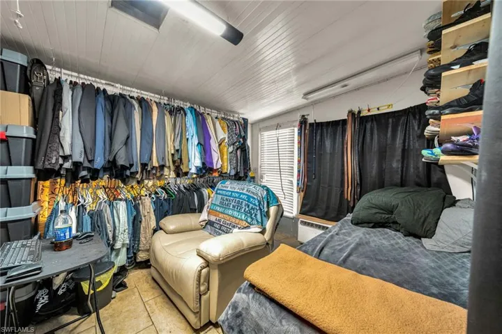 Walk in closet featuring tile patterned floors and a baseboard radiator