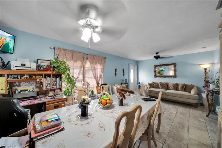 Dining space with a ceiling fan and a desk