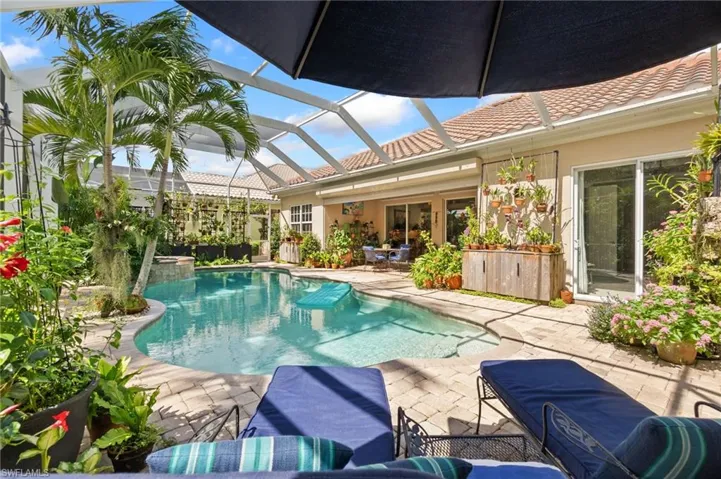 Swimming pool with a sunroom, a patio area, and a lanai