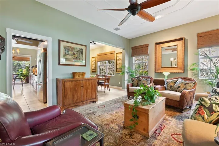 Tiled living room featuring ceiling fan