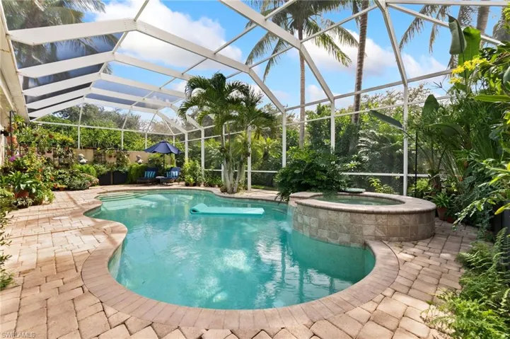 View of swimming pool with a patio, a lanai, a sunroom, and a pool with connected hot tub