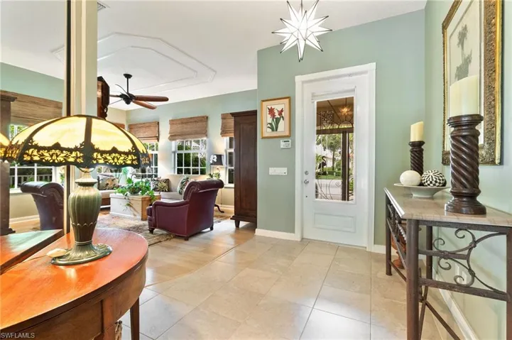 Foyer featuring ceiling fan and light tile patterned floors