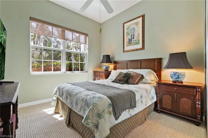 Carpeted bedroom featuring baseboards and ceiling fan
