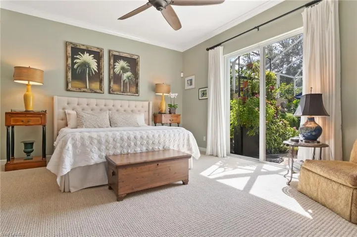 Bedroom with carpet flooring, ornamental molding, access to exterior, and ceiling fan
