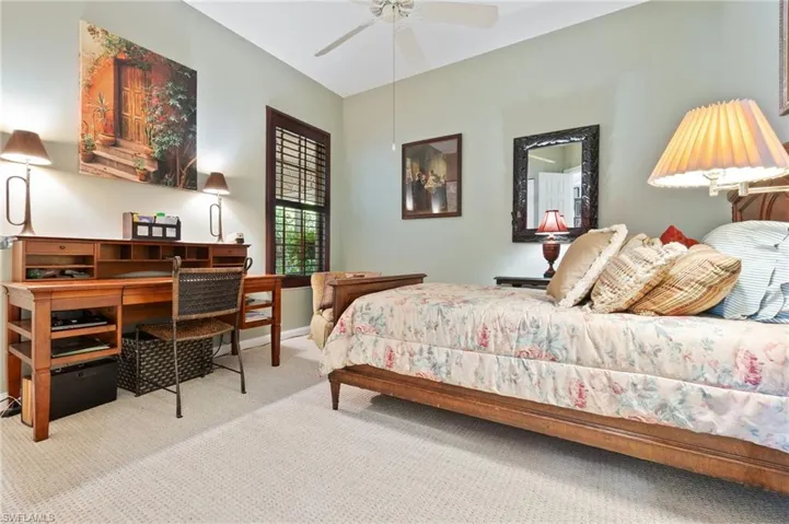 Carpeted bedroom with baseboards and ceiling fan
