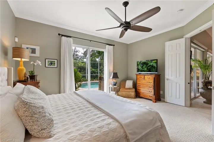 Carpeted bedroom with access to exterior, ornamental molding, and ceiling fan
