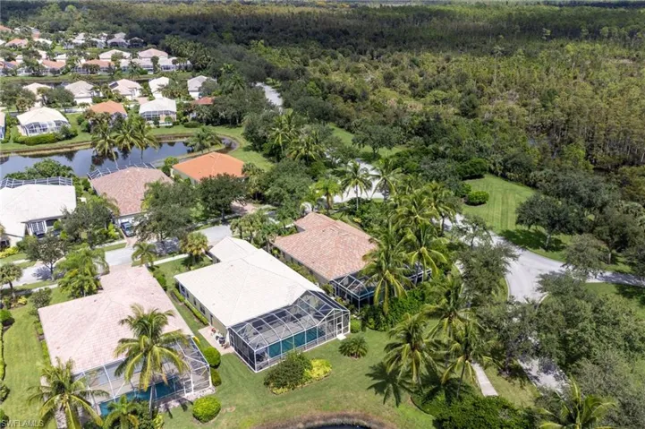 Aerial perspective of suburban area featuring a nearby body of water