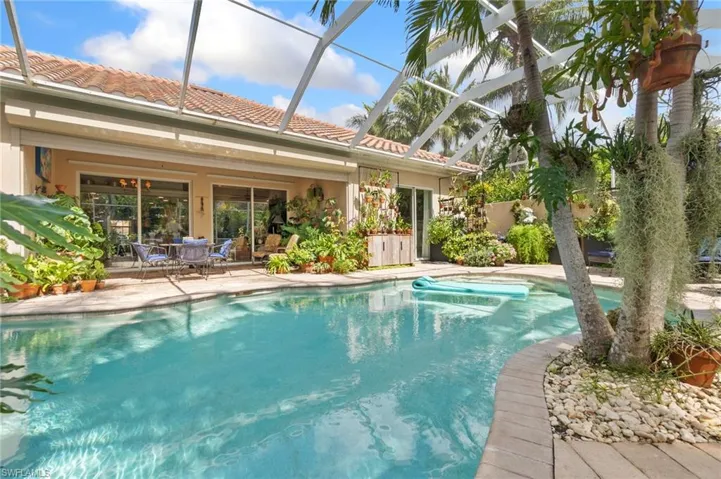 Outdoor pool with a lanai, a patio, and a sunroom