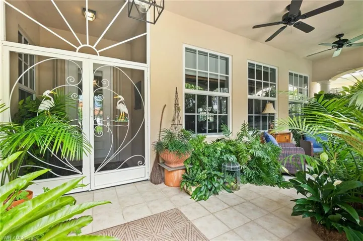 Property entrance featuring stucco siding and a ceiling fan