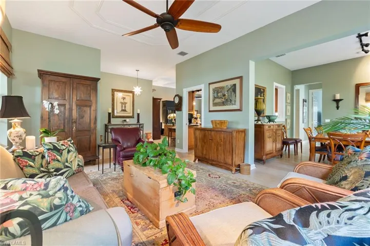 Living area with wood finished floors, a ceiling fan, and a chandelier