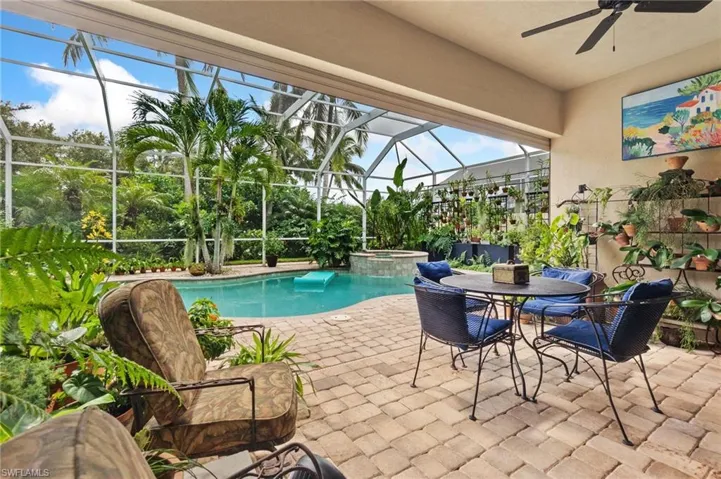 View of pool featuring a patio, a sunroom, ceiling fan, a lanai, and a pool with connected hot tub